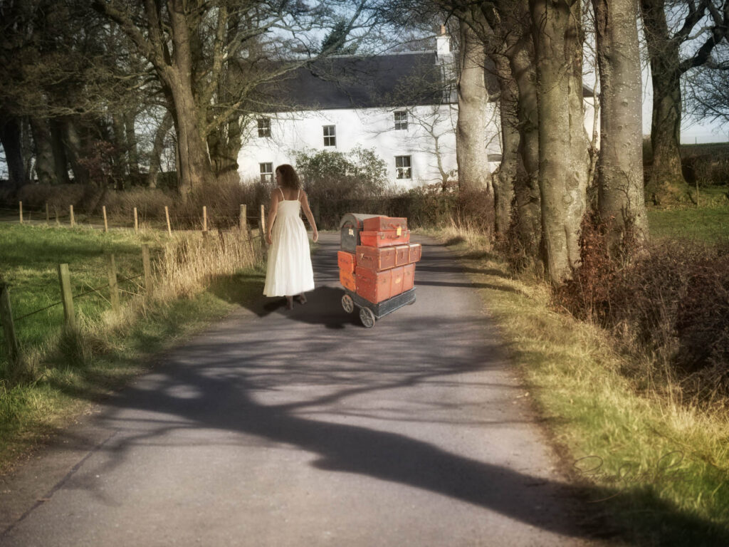 Woman portrait on a path at the country side with luggages